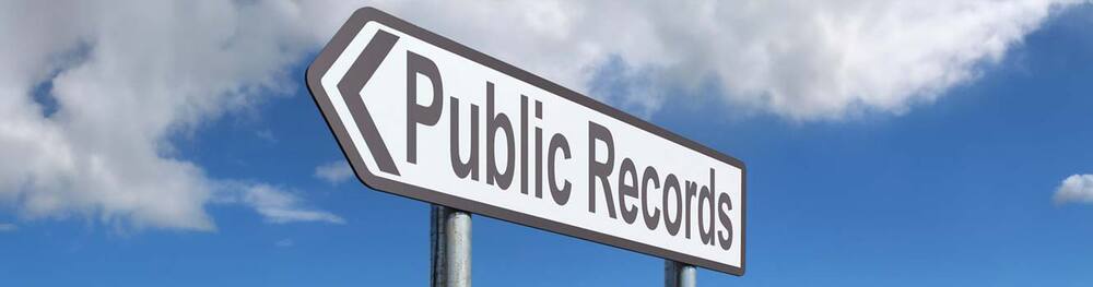Public Records sign with blue sky and clouds.