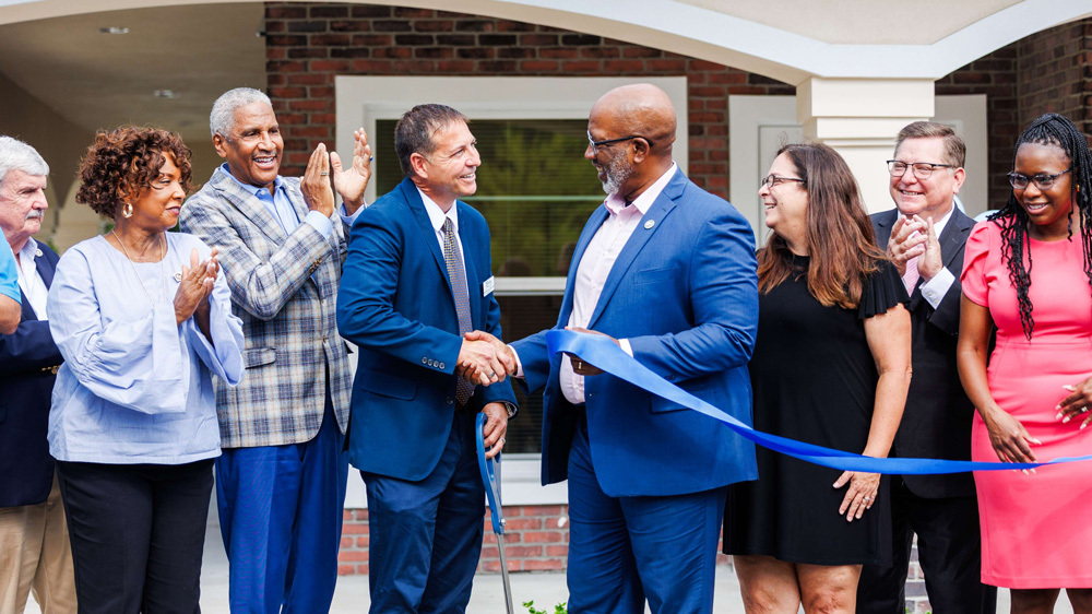 Group of people at Whispering Pines Apartments Grand Opening.