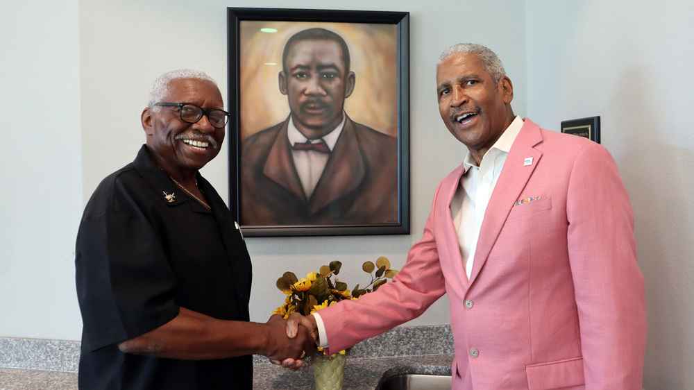 Reverend Dr. Basha Jordan, Jr. and Michael Lundy, President and CEO of the St. Petersburg Housing Authority (SPHA) shaking hands.