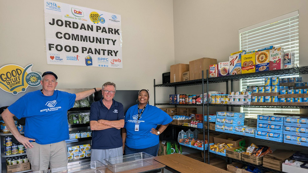 Three members of the Boys & Girls Clubs of the Suncoast in the Jordan Park Community Food Pantry.