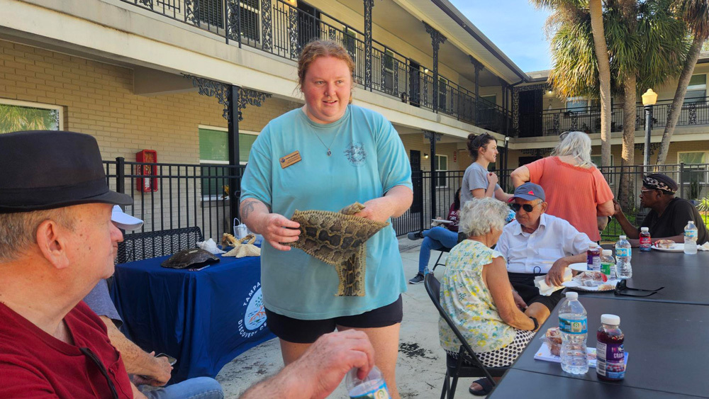 Tampa Bay Watch team members visiting senior residents at Sunset Oaks Apartments.