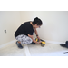 A team member from the St. Petersburg Housing Authority (SPHA) working on the baseboards inside Habitat for Humanity house.