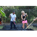 Two SPHA team members holding shovels in the Jordan Park Community Garden on August 8, 2024.