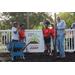 Five people unveiling the new Jordan Park Community Garden sign on August 8, 2024.