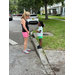 SPHA team member and a child outside the Jordan Park Community Garden on August 8, 2024.