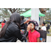 Child wearing red shirt getting their face painted at Very Merry Holiday Party in Jordan Park.