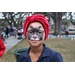 Child with face paint and wearing a dark blue shirt at Very Merry Holiday Party in Jordan Park.