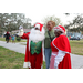 Mr. and Mrs. Santa Claus and a woman wearing a green shirt at Very Merry Holiday Party in Jordan Park.