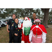 Mr. and Mrs. Santa Claus with three police officers at Very Merry Holiday Party in Jordan Park.