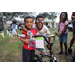 Two children and a bicycle at Very Merry Holiday Party in Jordan Park.