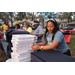 Woman wearing blue reindeer antlers and Domino's pizza at Very Merry Holiday Party in Jordan Park.