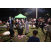 Children hula hooping with green tent in background at Very Merry Holiday Party in Jordan Park.