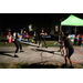 People hula hooping at night time during Very Merry Holiday Party in Jordan Park.